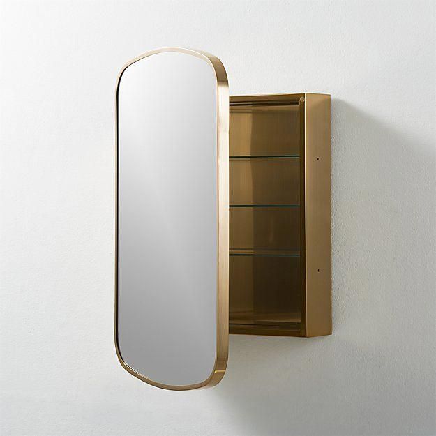 a mirror mounted to the side of a white wall next to a shelf with shelves