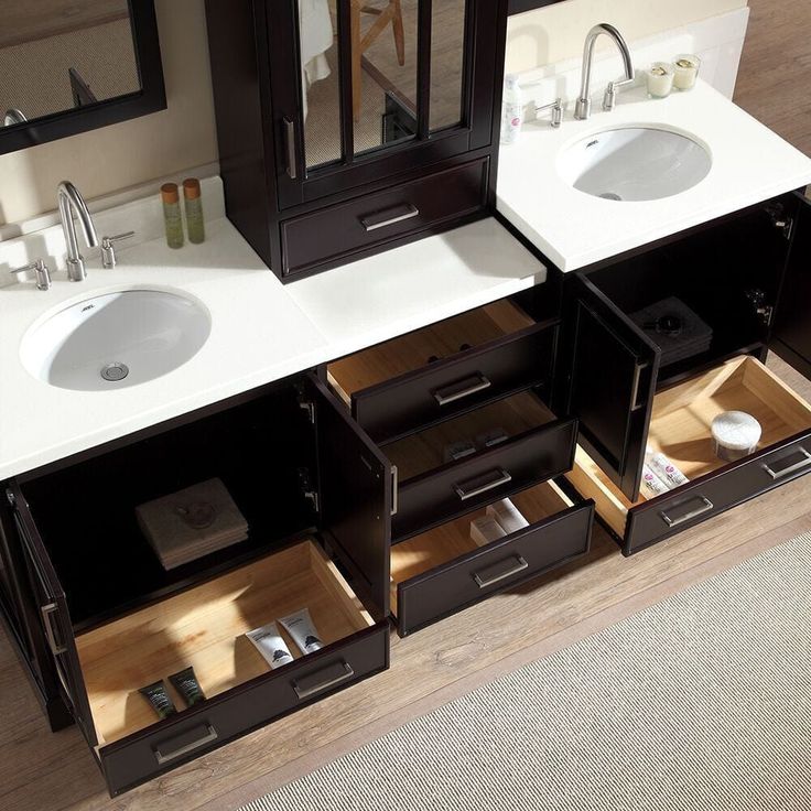 a bathroom with double sinks and two mirrors