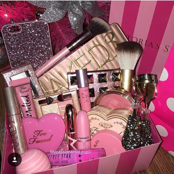 a pink box filled with lots of makeup