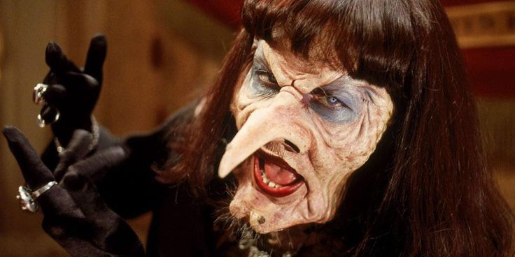 a woman with long hair and blue eyes is dressed up as a corpse from the addams movie