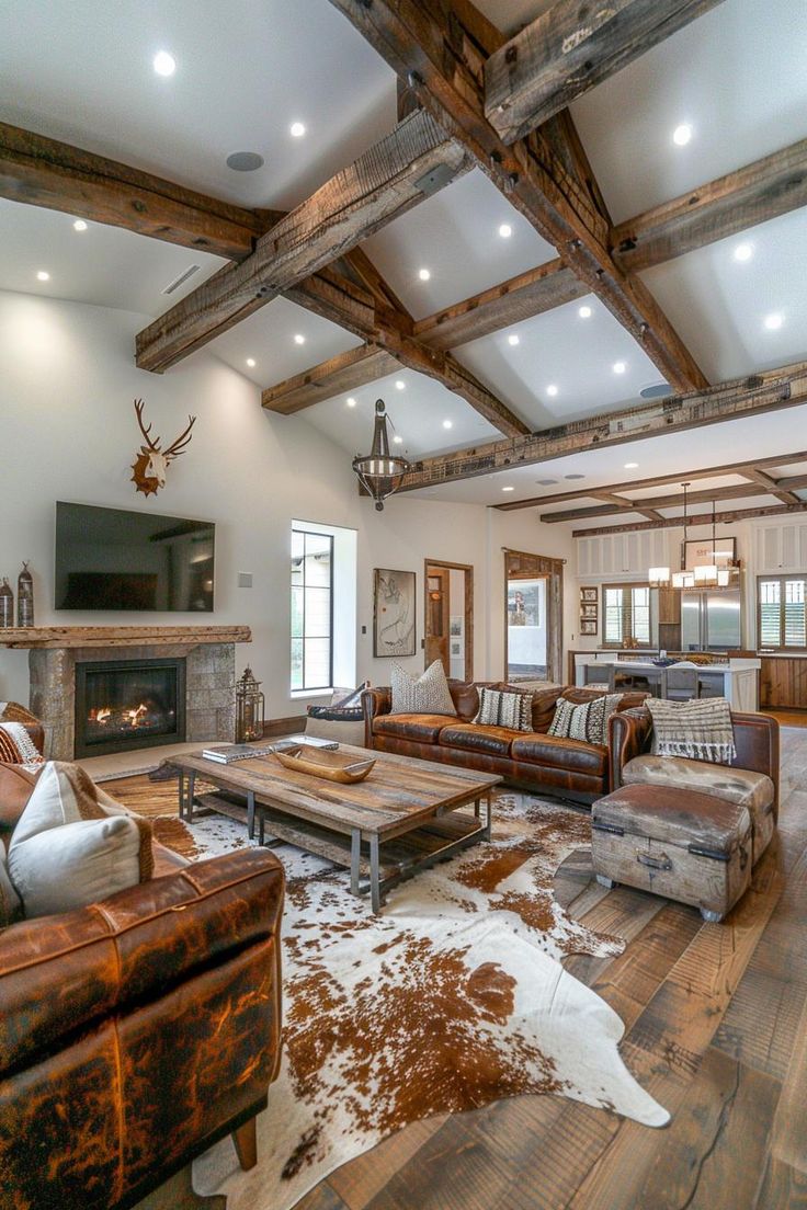 a living room with couches, chairs and a fireplace