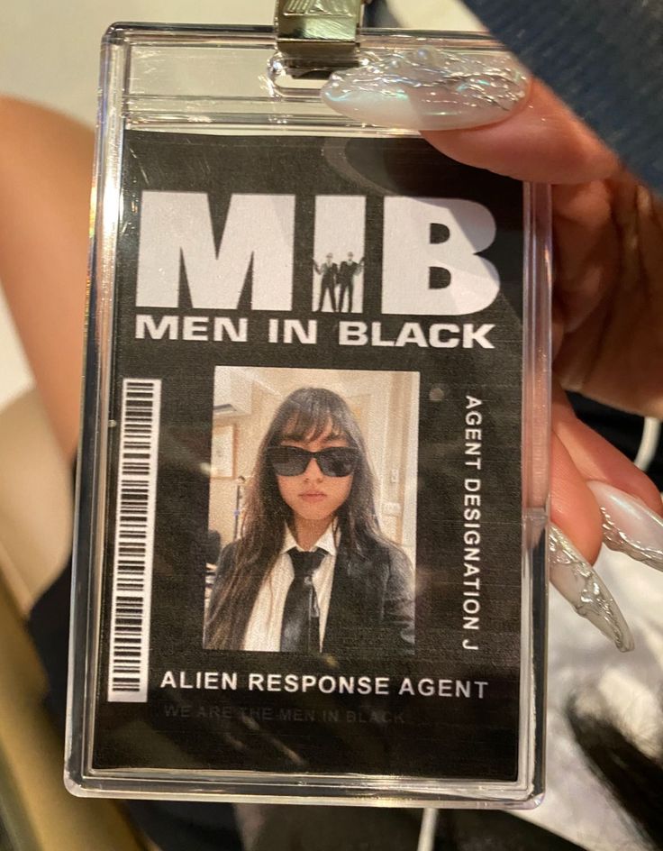 a person is holding up a badge for men in black