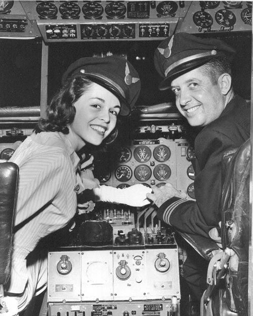 a man and woman are in the cockpit of an airplane