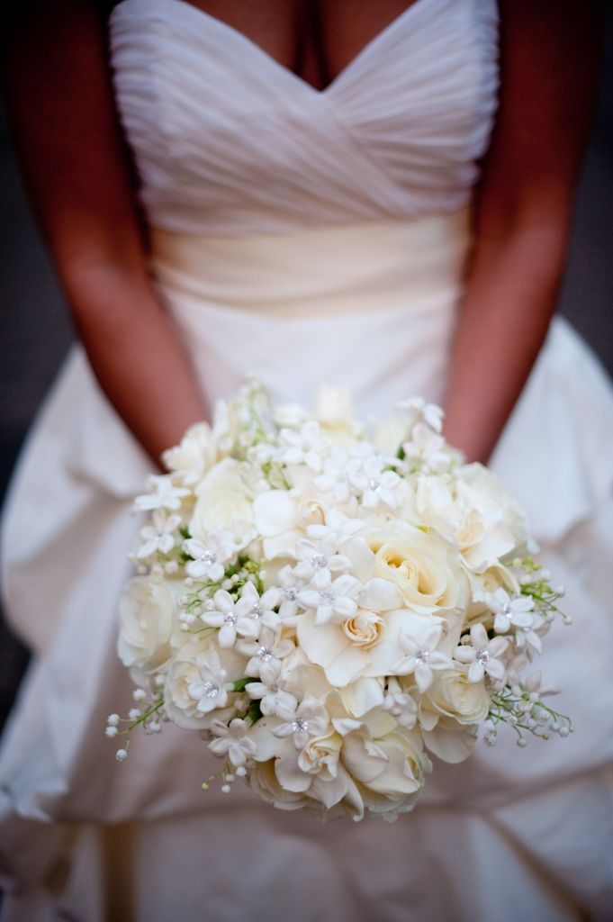 a bridal holding a bouquet of white flowers