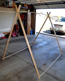 a garage with a car parked in it and a ladder attached to the side of the garage