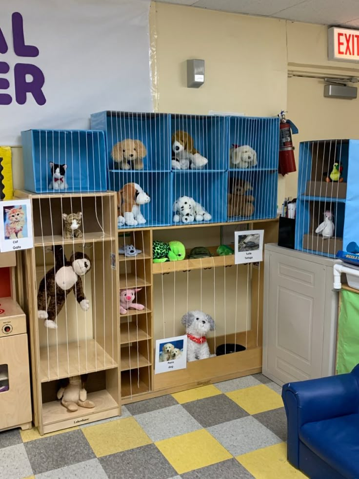 a room filled with lots of stuffed animals in cages next to a blue chair and yellow checkered floor