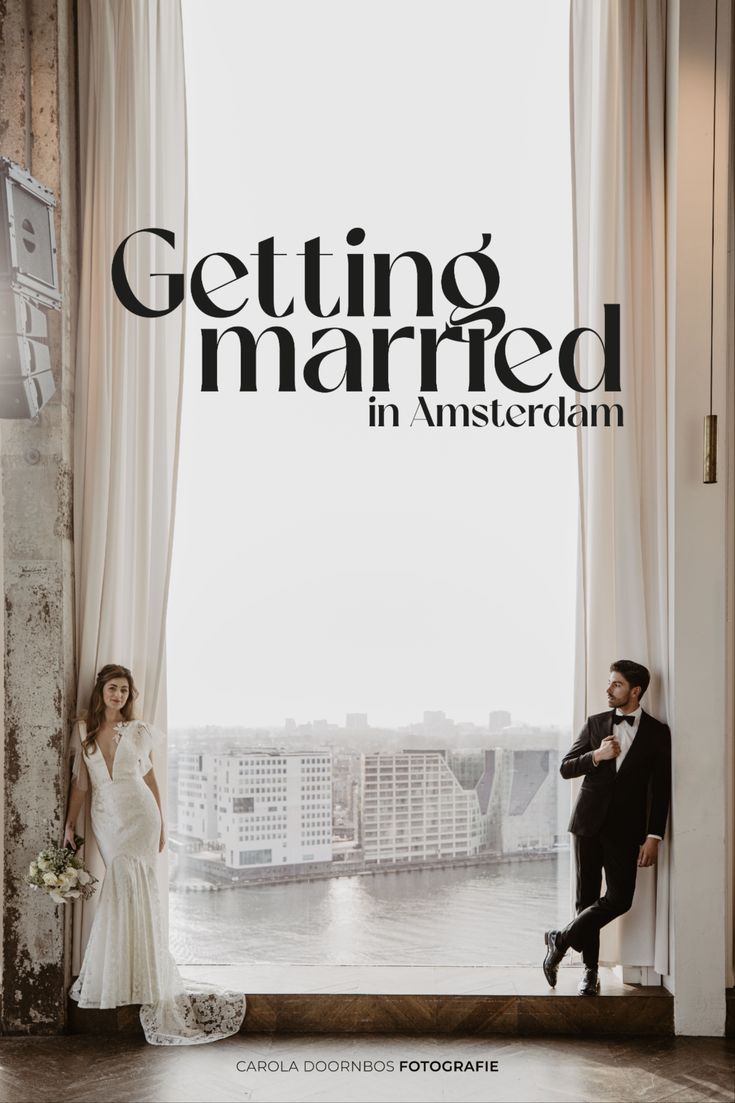 a man and woman standing next to each other in front of a window with the words getting married in amsterdam