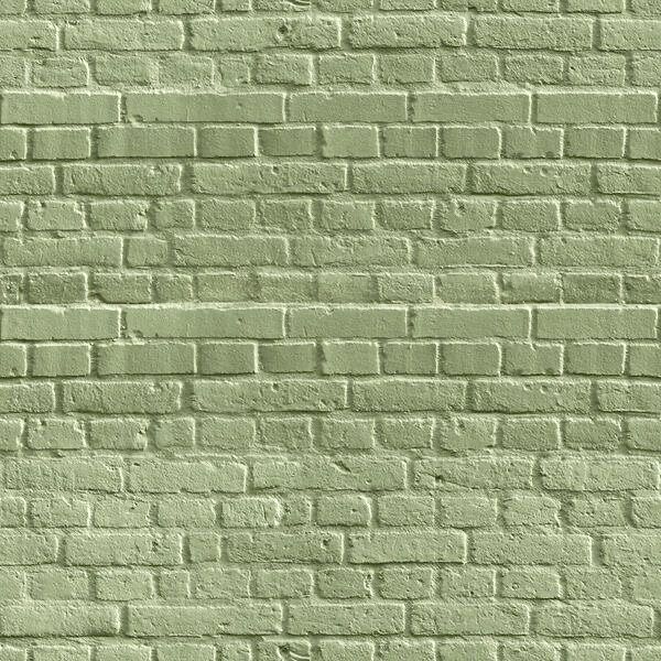 a green brick wall that is very close to the ground