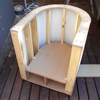 an unfinished chair sitting on top of a wooden floor