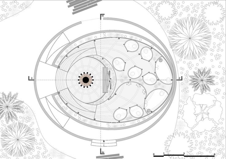 an aerial view of a circular building surrounded by trees