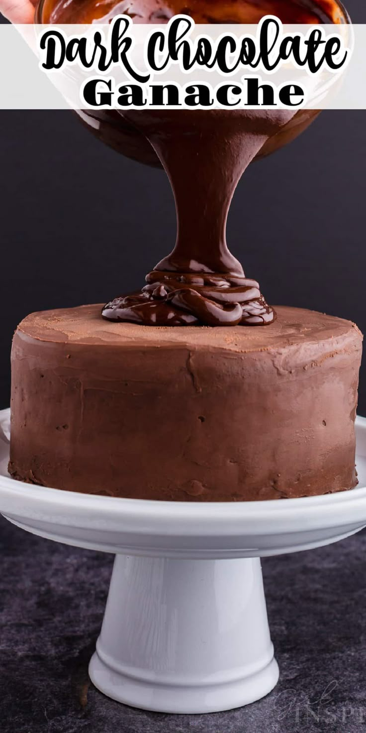 a chocolate cake on a white plate with the words dark chocolate ganache over it