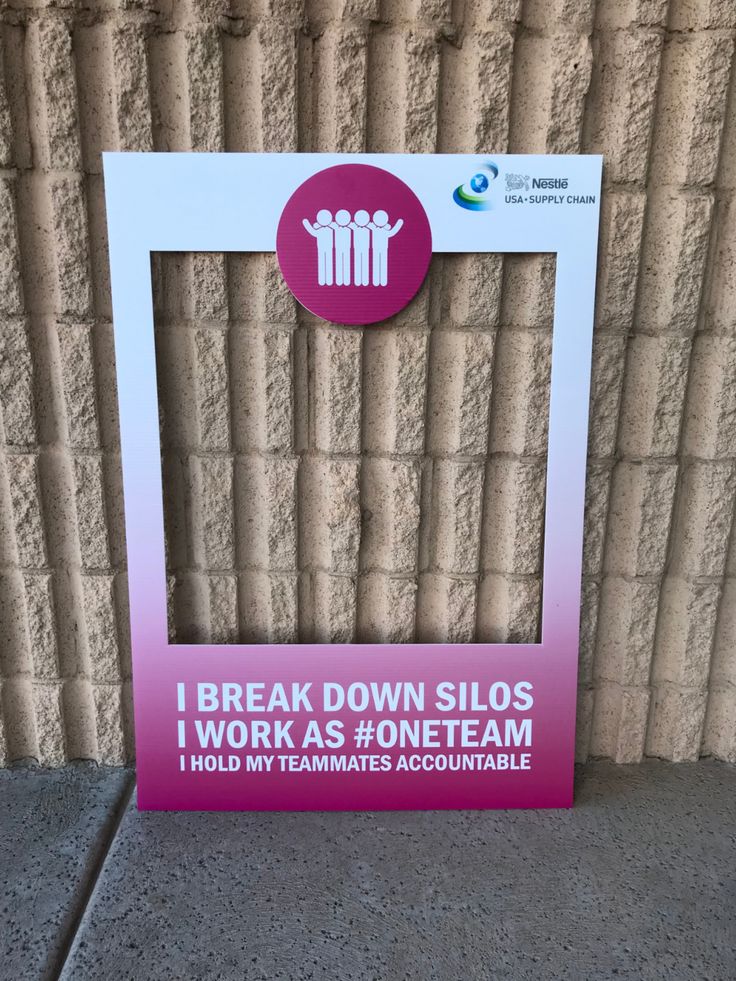 a sign on the side of a building that says break down slosss i work as oneteam hold my teammates accountable