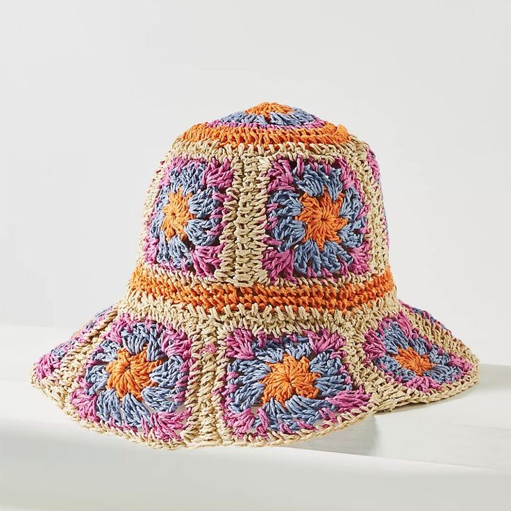 a multicolored crocheted hat sitting on top of a white countertop