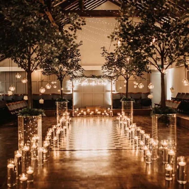 an indoor wedding with candles and trees