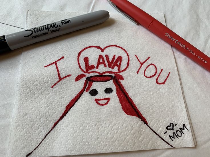 i lava you embroidered onto a napkin with a red marker next to it on a table