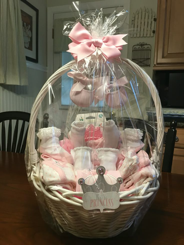 a basket filled with baby items on top of a wooden table