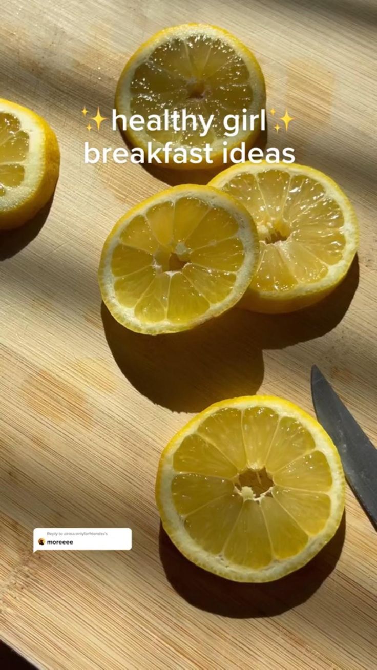 sliced lemons sitting on top of a cutting board next to a knife