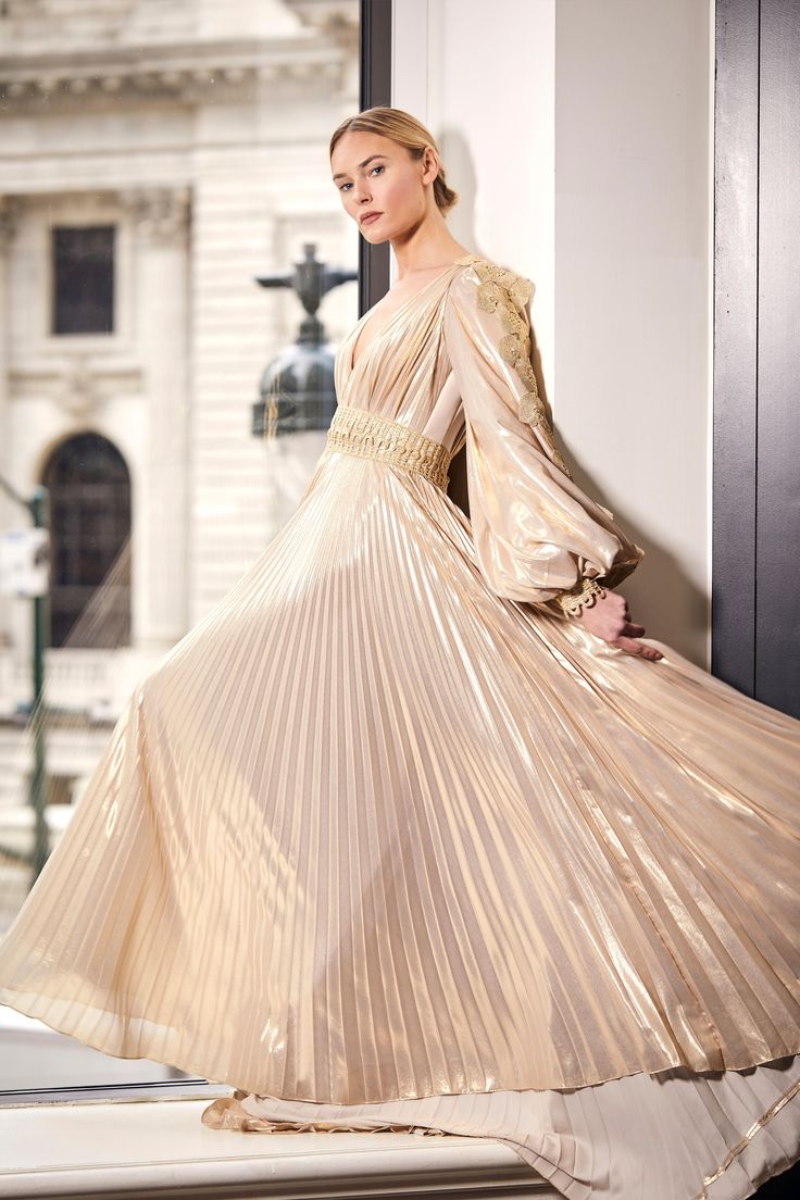 Deep V long sleeve metallic lame pleated gown Satin Mermaid Gown, Gold Ball Gown, Dramatic Sleeves, Pleated Gown, Mermaid Gown, Boutique Brands, Bridal Collection, Ball Gown, Deep V