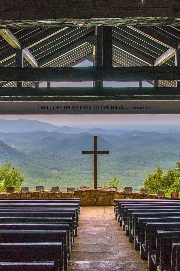 an empty church with mountains in the background