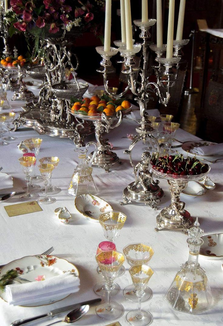 the table is set with silverware and candles