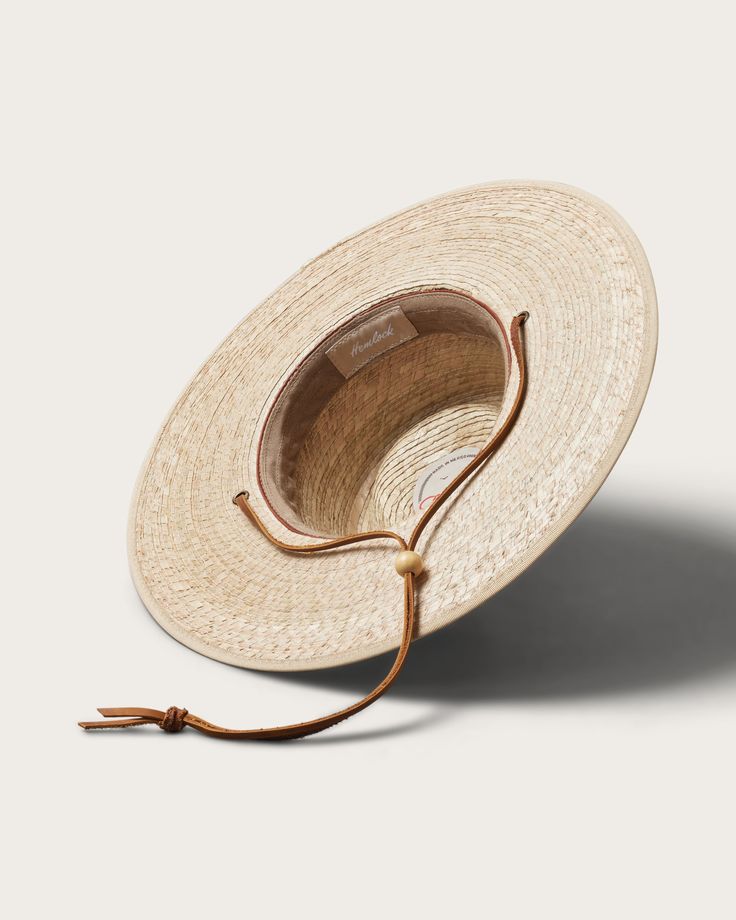 Discover the perfect blend of style and practicality with our Morro Fedora, handwoven by artisans from 100% tripilla palm straw. This lightweight accessory features a low depth fedora crown and an adjustable leather drawstring, making it an ideal choice for beachgoers and pool loungers alike. Lifeguard Hat, Straw Fedora Hat, Pool Lounger, Hat Size Chart, Straw Fedora, Boater Hat, Kids Beanies, Fedora Hat, Hat Shop