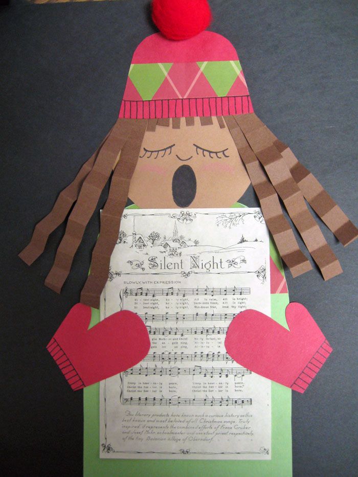 a paper doll made to look like a girl holding sheet music