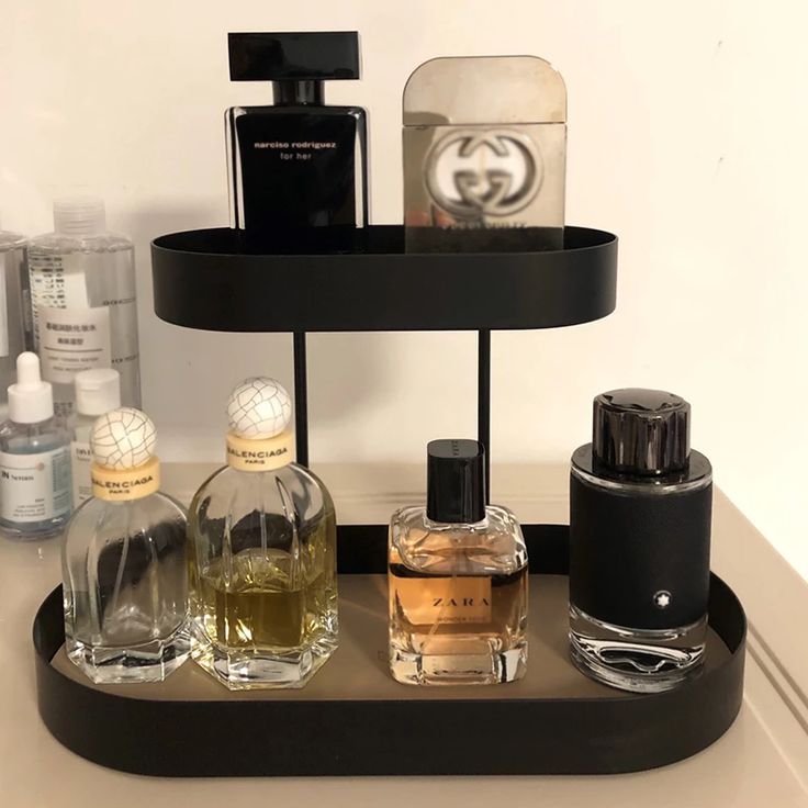 an assortment of perfumes are arranged on a tray