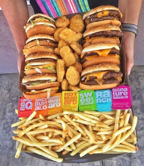 a box filled with lots of different types of food next to french fries and burgers