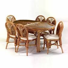 a wicker dining table with six chairs and a white back drop cloth seat cushion