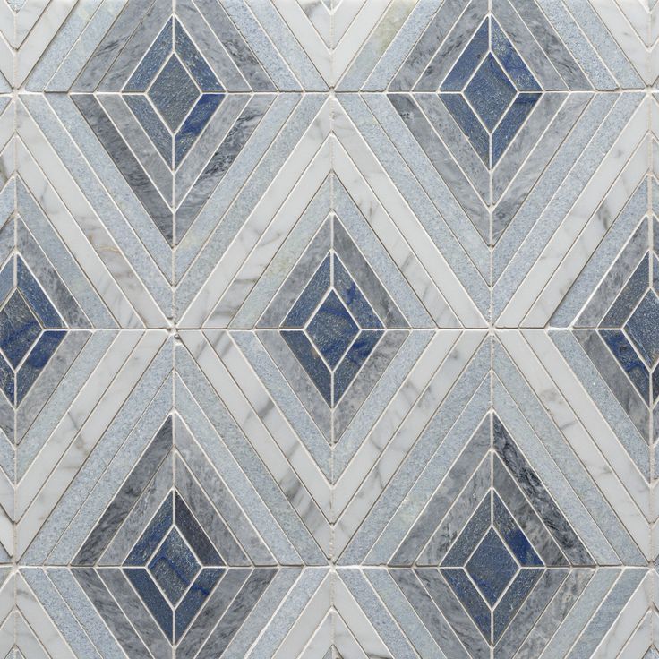 a white and blue tiled wall with diamond shapes