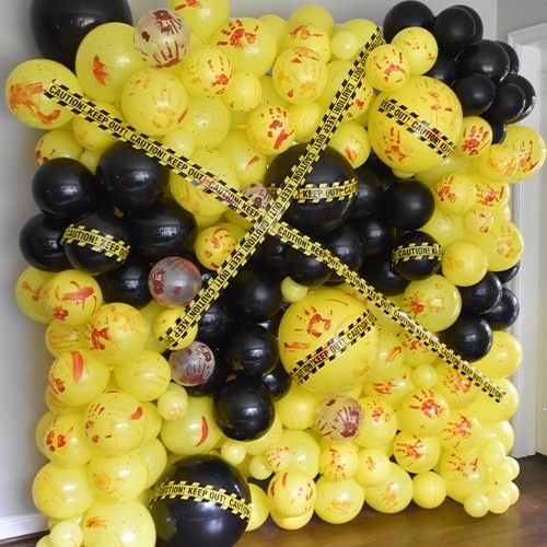 a bunch of balloons that have been taped together with yellow and black tape on them