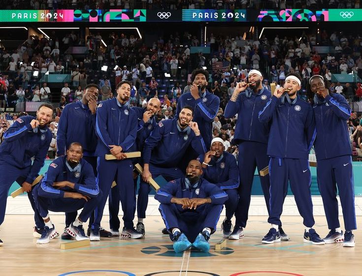 the us men's basketball team poses for a group photo after winning the gold medal