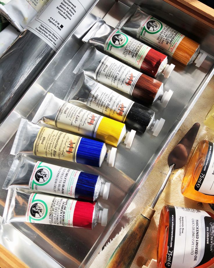 an open drawer with many different types of paint in it