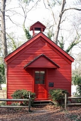 a small red church with a steeple on top