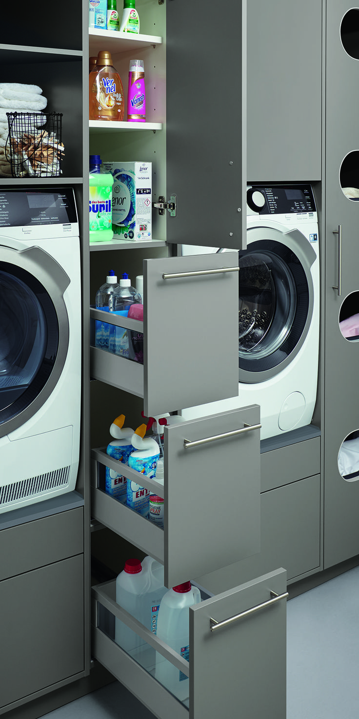 a washer and dryer in a room next to each other with shelves on the wall