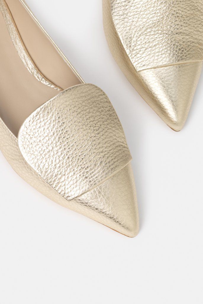 The Lia Gold Elegant Evening Ballet Flats With Textured Sole, Luxury Gold Ballet Flats, Elegant Metallic Closed Toe Flats, Luxury Gold Flats For Evening, Luxury Gold Flats, Elegant Gold Pointed Toe Flats For Formal Occasions, Luxury Gold Flats For Spring, Elegant Ballet Flats With Textured Sole, Elegant Metallic Flats For Party