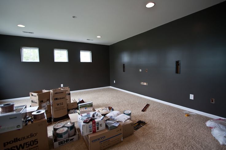 an empty room with boxes and other items on the floor