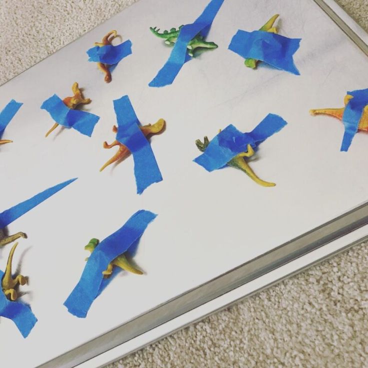 an open book with blue origami dinosaurs on it