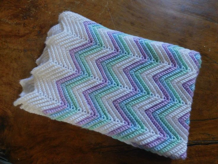 a crocheted dishcloth sitting on top of a wooden table