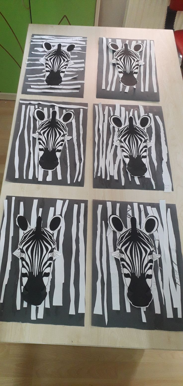 four zebras painted on black and white paper