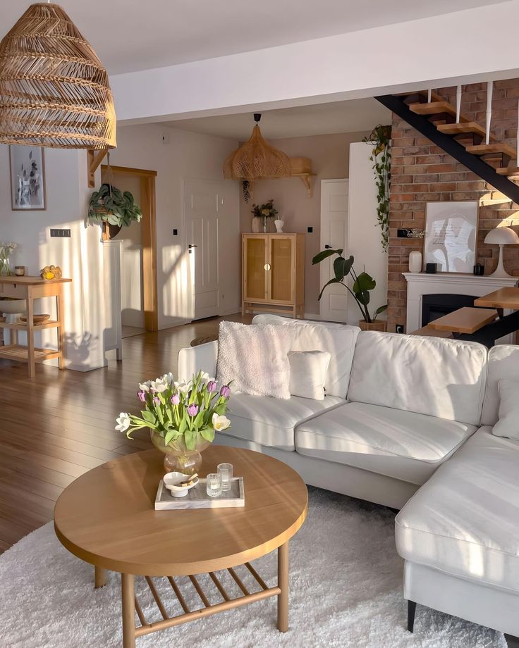 a living room filled with furniture and a staircase