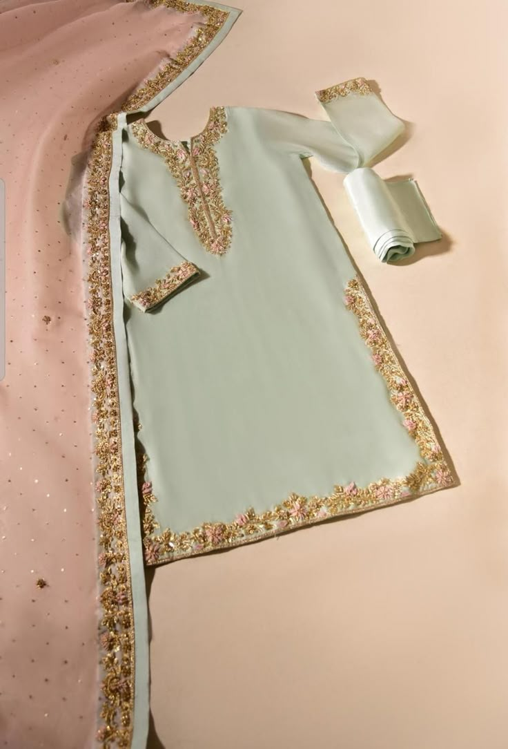 This beauty is canvassed on pure organza with gold hand craftmenship with 3D handmade petals, paired with a teapink dupatta with heavy zardosi work and matching raw silk trousers. Delivery Time:   4 to 6 weeks Agha Noor, Desi Outfits, Zardosi Work, Desi Wear, Pakistani Fashion Casual, Dress Book, Stylish Short Dresses, Pakistani Dresses Casual, Pakistani Fashion Party Wear