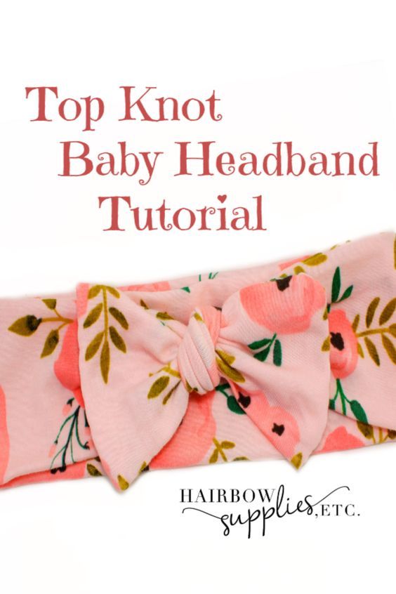 the top knot baby headband has pink flowers on it