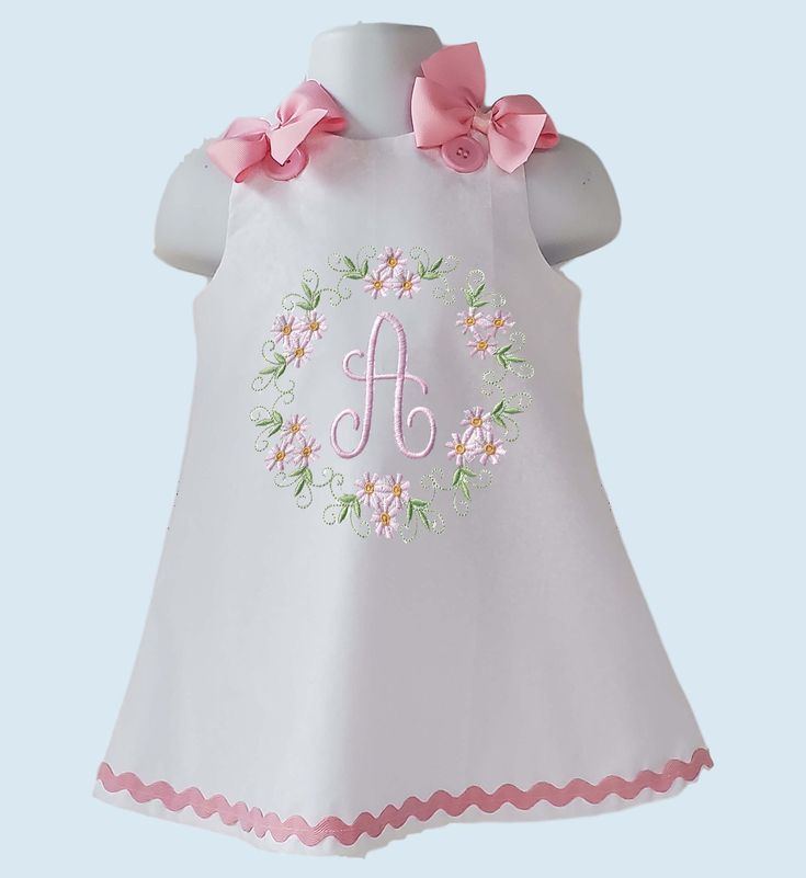 Beautiful A-line/Jumper dress with your little girl Initial or Age embroider. Initial or Age embroider design. Dress is done in a white cotton fabric.  The dress closes in the at shoulder with buttons, bows are pinned at shoulder for an easy removal. Bodice fully lined, we finish all seams with a serger for a professional look and long lasting. All our items are handmade and made to order. If your order needs to be done and ship before my turnaround ( ship date in your order ) please mention date needed in Notes To Seller. We recommend washing inside out on gentle cycle and hang to dry or low heat. Do not use bleach. Iron inside out on low heat. Created in a smoke free studio. If any question please do not hesitate to contact us. Cute Floral Applique Dress For Birthday, Sleeveless Floral Applique Dress For Birthday, Sleeveless Dress With Floral Applique For Birthday, Sleeveless Floral Embroidered Baptism Dress, Cute White Dress With Embroidered Hem, Cute Embroidered White Dresses, Cute White Embroidered Dresses, White Cotton Dress For Birthday, White Cotton Dress With Machine Embroidery