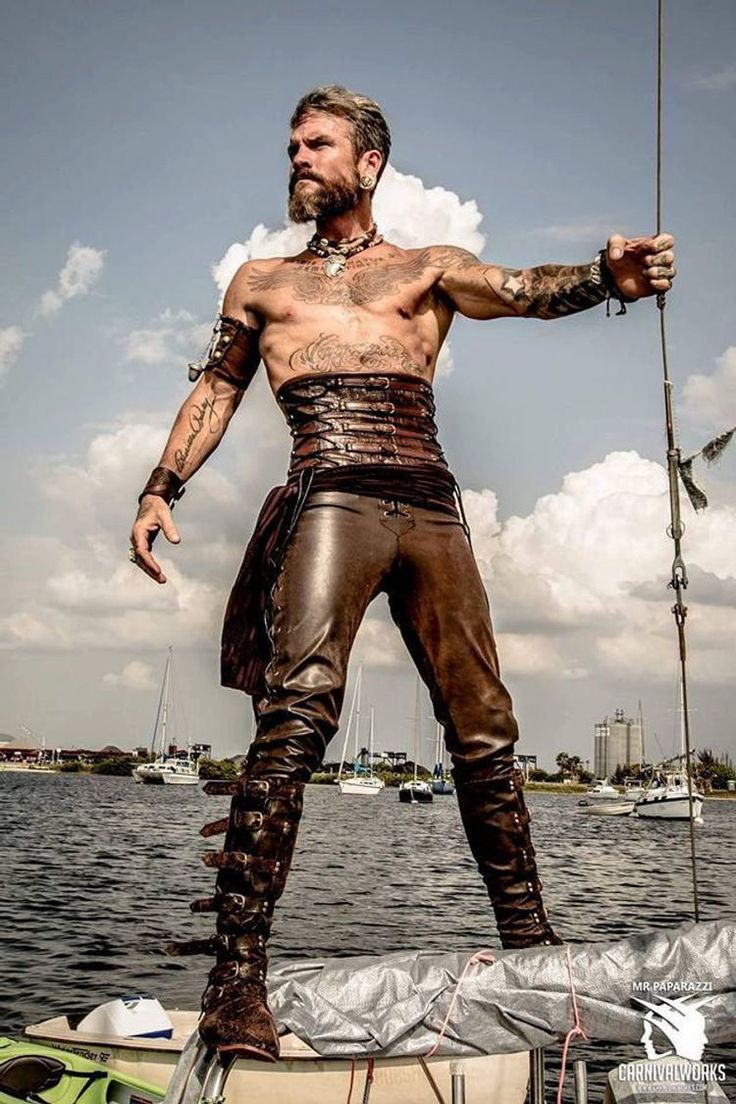 a man standing on top of a boat in the water