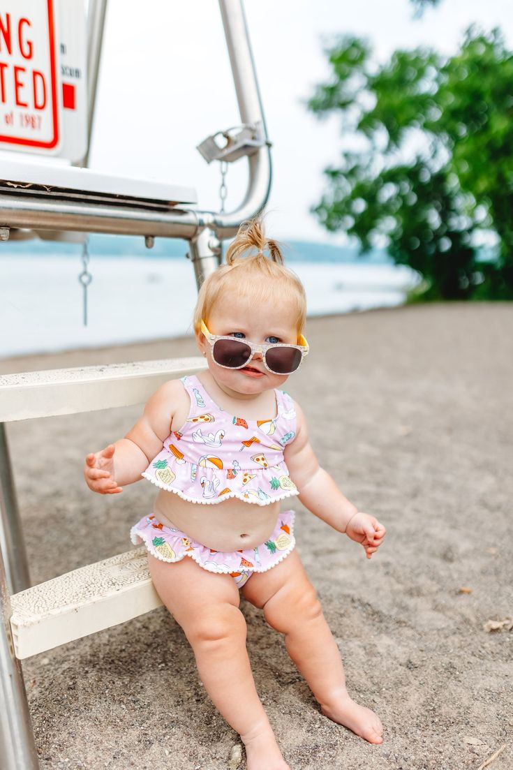 Take the poolside party everywhere you go with this dreamy two-piece tankini set! From its UPF 50+ sun protection to its ruffle details, this outfit will keep your little one comfy and cool as a cucumber all summer long (and look good doing it!). Get your P.O.O.L.S.I.D.E. on! All new and girlie Dream Tankini Two Piece Swim Suit! Made with comfort and stretch in mind, this eye-catching suit features a pom-pom trim and ruffled top and bottom for maximum style and beach-loving vibes. Our UPF 50+ sw Summer Ruffled Swimwear For Beach Season, Upf 50+ Swimwear For Beach Season Playtime, Summer Swimwear With Upf 50+ For Playtime, Summer Ruffled Tankini For Pool, Playful Fitted Swimwear With Upf 50+, Upf 50+ Swimwear For Summer Playtime, Upf 50+ Swimwear For Summer, Fitted Swimwear For Summer Playtime, Ruffled Swimwear For Pool And Beach Season