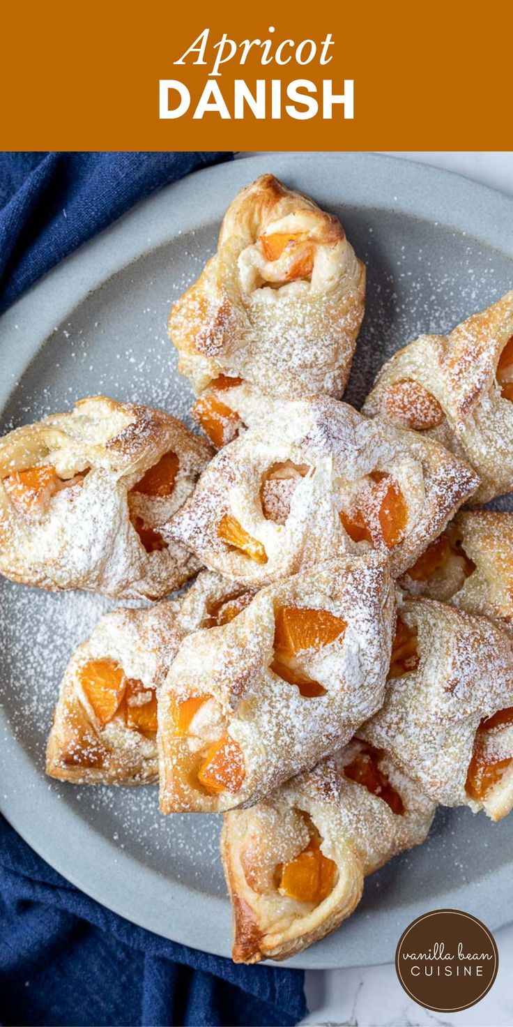 apricot danish pastries on a plate with powdered sugar