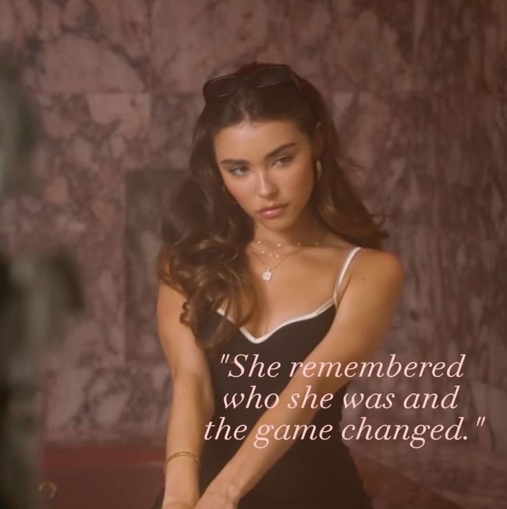 a woman in a black and white dress holding a tennis racquet with a quote on it