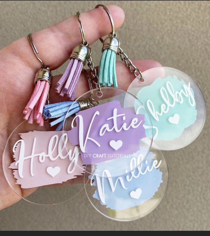 three keychains with tassels on them that say hello kitty, mary and minnie