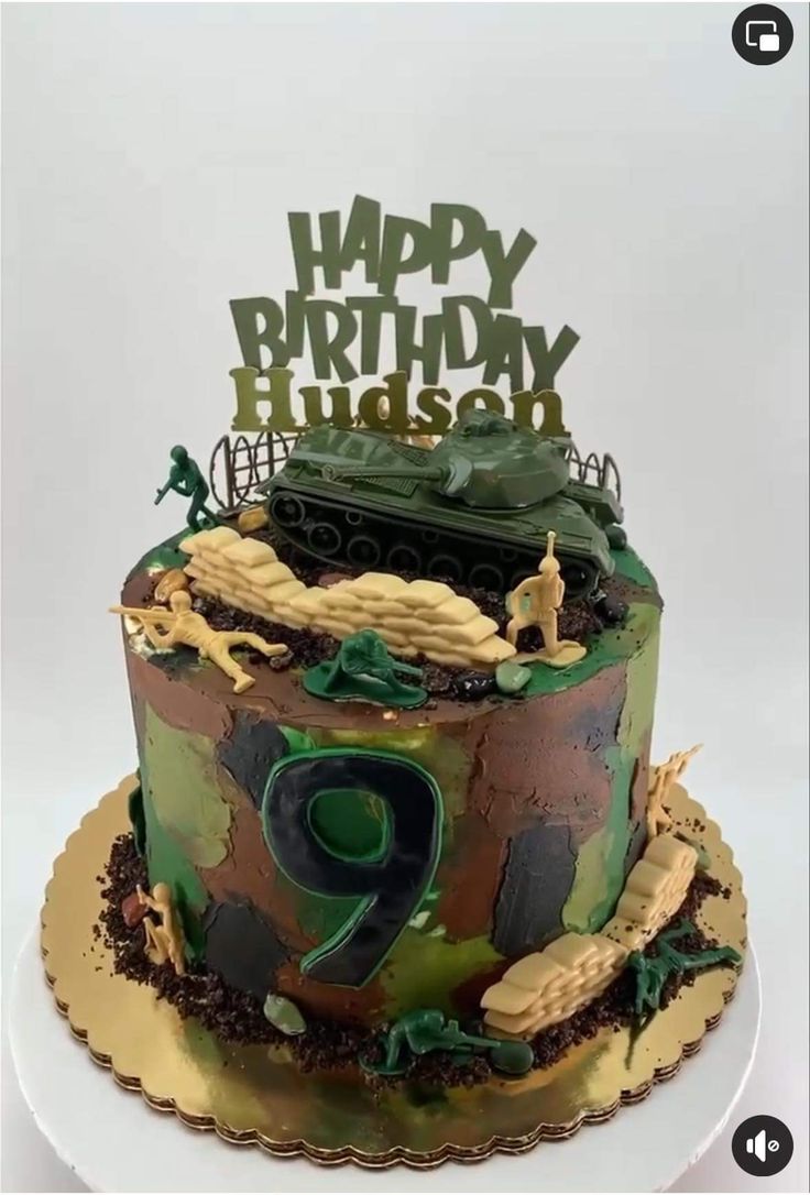 a camouflaged birthday cake with the number two on it and an army tank in the middle